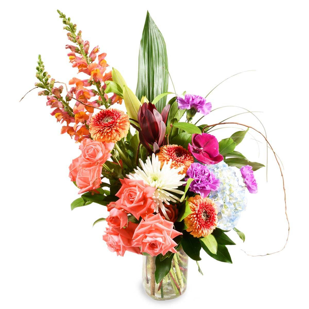 Arrangement in a glass vase with assorted colour flowre sfor a birthday, includes spray roses, spray mums, gerbera and hydrangea.