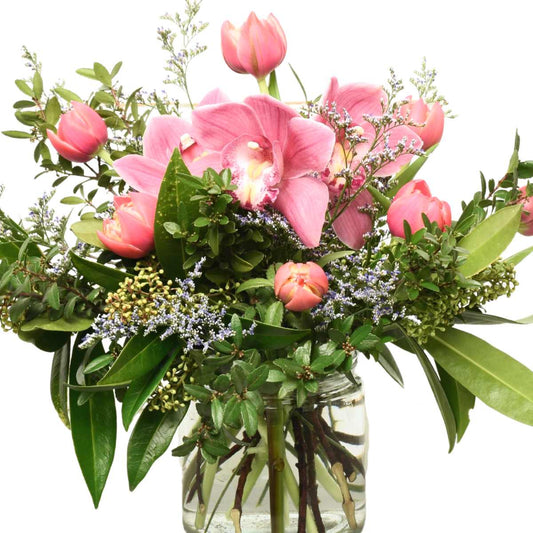 A flower arrangement with tulups and orchids for delivery in Burnaby BC
