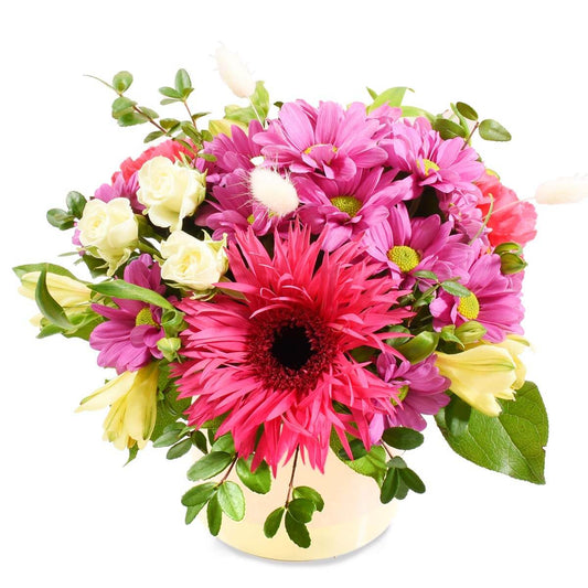 Ceramic vase with hot pink and mauve flowers, includes gerbera, chrysanthemums and mini roses