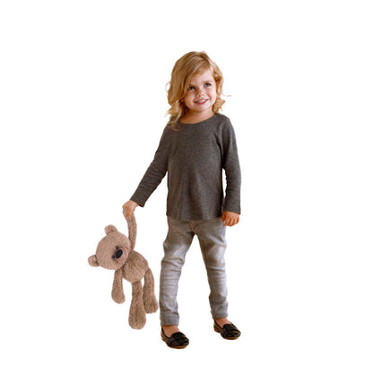 Young girl holding a tan coloured teddy bear