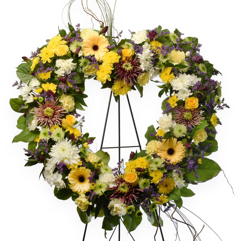 Heart shaped funeral wreath tribute with a mix of fresh flowers