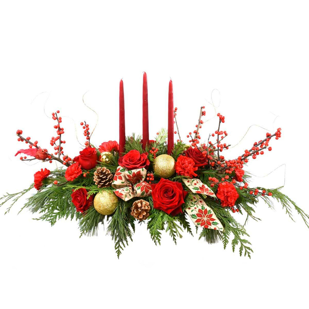 Christmas table centrepiece with red flowers and candles in Vancouver BC