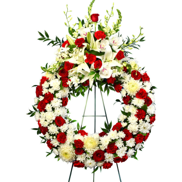 Funeral wreath with red roses and carnations and white flowers for delivery in Burnaby Canada